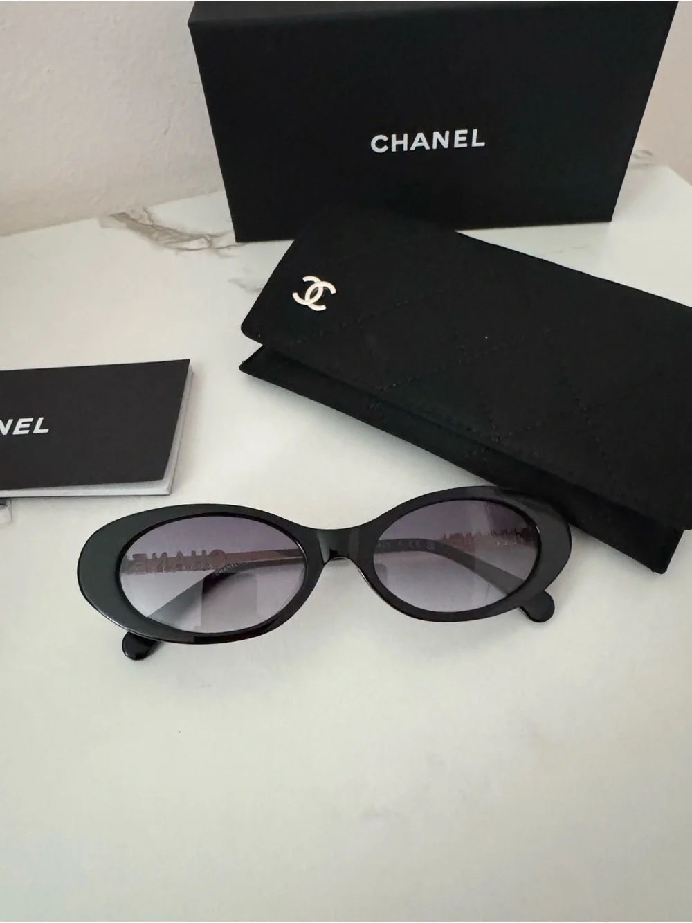 CHANEL Black Oval Sunglasses with Gray Gradient Lenses